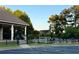 Gated community pool area with lounge chairs, tables, umbrellas and mature landscaping, offering a serene retreat at 60 Saddle Tree Way, Sugar Hill, GA 30518