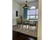 Bright dining room featuring large arched window, turquoise drapes and a modern chandelier at 60 Saddle Tree Way, Sugar Hill, GA 30518