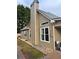Exterior view of a home featuring neutral siding, white trim, a chimney, and manicured landscaping at 60 Saddle Tree Way, Sugar Hill, GA 30518