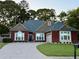 Charming single-story brick home with a well-manicured lawn, mature trees, and a curved driveway at 60 Saddle Tree Way, Sugar Hill, GA 30518