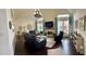 Elegant living room featuring hardwood floors, vaulted ceilings, a fireplace, and stylish furnishings at 60 Saddle Tree Way, Sugar Hill, GA 30518