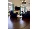 Inviting living room featuring hardwood floors, a fireplace, and comfortable leather seating at 60 Saddle Tree Way, Sugar Hill, GA 30518