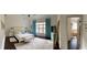 Spacious main bedroom featuring hardwood floors, natural light, and an en-suite bathroom at 60 Saddle Tree Way, Sugar Hill, GA 30518