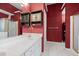 Bathroom with double vanity sink and ample lighting featuring bold red wallpaper at 840 Cline Petty Way Way, Lawrenceville, GA 30043