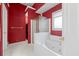 Bathroom featuring jacuzzi tub and enclosed shower with bright red wallpaper at 840 Cline Petty Way Way, Lawrenceville, GA 30043