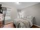 Comfortable bedroom with hardwood floors, warm-colored walls, and bright window at 840 Cline Petty Way Way, Lawrenceville, GA 30043