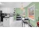 Sunlit kitchen with white cabinetry, modern appliances, and a cozy dining area at 840 Cline Petty Way Way, Lawrenceville, GA 30043