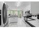 Well-lit kitchen featuring stainless steel appliances, ample counter space, and white cabinetry at 840 Cline Petty Way Way, Lawrenceville, GA 30043