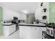 Bright kitchen with white cabinets, stainless steel appliances, and black-and-white tile accents at 840 Cline Petty Way Way, Lawrenceville, GA 30043