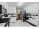 Modern kitchen featuring stainless steel appliances, white cabinetry, and an efficient layout at 840 Cline Petty Way Way, Lawrenceville, GA 30043