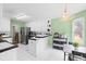 Bright kitchen with white cabinets, stainless steel appliances, and a black-and-white backsplash at 840 Cline Petty Way Way, Lawrenceville, GA 30043