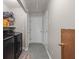 Convenient laundry room featuring modern appliances and ample storage shelving for optimal organization at 840 Cline Petty Way Way, Lawrenceville, GA 30043