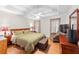 Cozy main bedroom featuring a ceiling fan, wood floors, and well-lit bedside tables at 840 Cline Petty Way Way, Lawrenceville, GA 30043