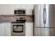 Close-up view of a stainless steel oven, microwave, and refrigerator with wood cabinets at 107 Timber Ridge Dr, Cartersville, GA 30121