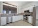 Modern kitchen with stainless appliances, tile backsplash, and open view to the living area at 107 Timber Ridge Dr, Cartersville, GA 30121