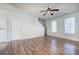 Bright living room featuring hardwood floors, two windows, and a ceiling fan with overhead lighting at 107 Timber Ridge Dr, Cartersville, GA 30121