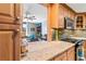 Kitchen area featuring stone countertops, stainless appliances, wood cabinetry, and access to living space at 130 26Th Nw St # 615, Atlanta, GA 30309