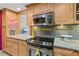 Gourmet kitchen featuring stainless steel appliances and stylish granite counters and wood cabinets at 130 26Th Nw St # 615, Atlanta, GA 30309