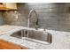 Modern kitchen faucet and sink with granite countertops and a stylish backsplash design at 130 26Th Nw St # 615, Atlanta, GA 30309