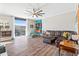 Bright living room featuring wood floors, a ceiling fan, and ample natural light from a large window at 130 26Th Nw St # 615, Atlanta, GA 30309