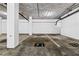 Underground parking garage with designated parking spots, concrete pillars, and overhead pipes at 130 26Th Nw St # 615, Atlanta, GA 30309