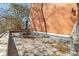 Outdoor patio featuring patio seating, a brick wall, and a view of trees and foliage at 130 26Th Nw St # 615, Atlanta, GA 30309