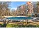 Outdoor pool area, covered for the season, surrounded by trees and condo buildings at 130 26Th Nw St # 615, Atlanta, GA 30309