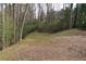 The property boasts a partially cleared backyard, offering a blend of natural beauty and usable space at 1932 Variations Ne Dr, Atlanta, GA 30329