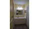 This bathroom has yellow walls, a single sink vanity, and an integrated medicine cabinet at 1932 Variations Ne Dr, Atlanta, GA 30329