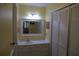 Well-lit bathroom with large mirror and louvred closet doors at 1932 Variations Ne Dr, Atlanta, GA 30329