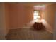 A bedroom with neutral carpeting, pink walls, and a small window at 1932 Variations Ne Dr, Atlanta, GA 30329