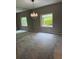 Traditional dining room with gray carpet, vintage chandelier and two windows with wooded outdoor views at 1932 Variations Ne Dr, Atlanta, GA 30329