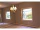 Dining room filled with natural light from the windows, features mirror wall and hanging chandelier at 1932 Variations Ne Dr, Atlanta, GA 30329