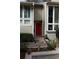Inviting front entrance with well maintained landscaping and a vibrant red front door at 1932 Variations Ne Dr, Atlanta, GA 30329