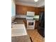 Bright kitchen features double sink, granite countertops, white appliances, and oak cabinets at 1932 Variations Ne Dr, Atlanta, GA 30329