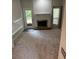Bright living room featuring soft carpeting, a cozy fireplace, and natural light streaming through the windows at 1932 Variations Ne Dr, Atlanta, GA 30329