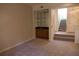 Carpeted living room showcasing the staircase and dry bar at 1932 Variations Ne Dr, Atlanta, GA 30329