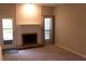 Spacious living room with a fireplace, outdoor access, and soft carpeting at 1932 Variations Ne Dr, Atlanta, GA 30329