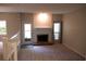 Cozy living room with a fireplace, access to outdoor space, and soft carpet at 1932 Variations Ne Dr, Atlanta, GA 30329