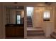 Living room showcasing the staircase and dry bar with glass shelves and cabinet at 1932 Variations Ne Dr, Atlanta, GA 30329