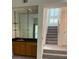 Cozy wet bar features dark granite counters, wood cabinets, a mirror backsplash and floating shelves at 1932 Variations Ne Dr, Atlanta, GA 30329