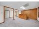 Spacious finished basement with wooden paneling and carpeted floors at 395 Lake Swan Ct, Hiram, GA 30141