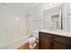 Bright bathroom features a shower and tub combination, wood-look flooring, and modern vanity at 395 Lake Swan Ct, Hiram, GA 30141