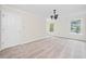 Carpeted bedroom features natural light, neutral paint, and a decorative chandelier at 395 Lake Swan Ct, Hiram, GA 30141