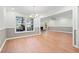 Bright dining room featuring beautiful wood floors, neutral walls, and a modern chandelier at 395 Lake Swan Ct, Hiram, GA 30141