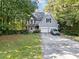 Charming two-story home with mature trees, two-car garage and a long driveway at 395 Lake Swan Ct, Hiram, GA 30141