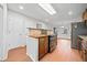 Eat-in kitchen features stainless steel appliances, tile backsplash and wood cabinets at 395 Lake Swan Ct, Hiram, GA 30141