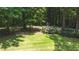 A lush, green backyard provides a serene outdoor space, surrounded by mature trees at 1165 E Beechwood Nw Dr, Atlanta, GA 30327