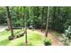 A well-maintained backyard features beautiful landscaping and a peaceful wooded backdrop at 1165 E Beechwood Nw Dr, Atlanta, GA 30327