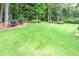 Expansive backyard featuring a well-maintained lawn, mature trees, and lush landscaping at 1165 E Beechwood Nw Dr, Atlanta, GA 30327